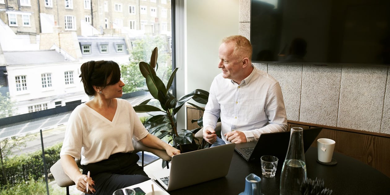 man and woman in office